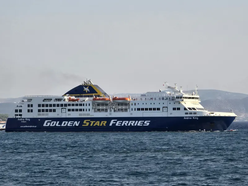 The Golden Star Ferries ship Andros King, with a dark blue hull and white decks, under way off Rafina